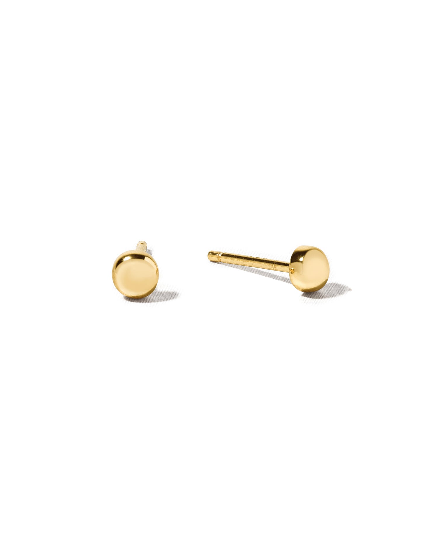 Gold stud earrings on a white background