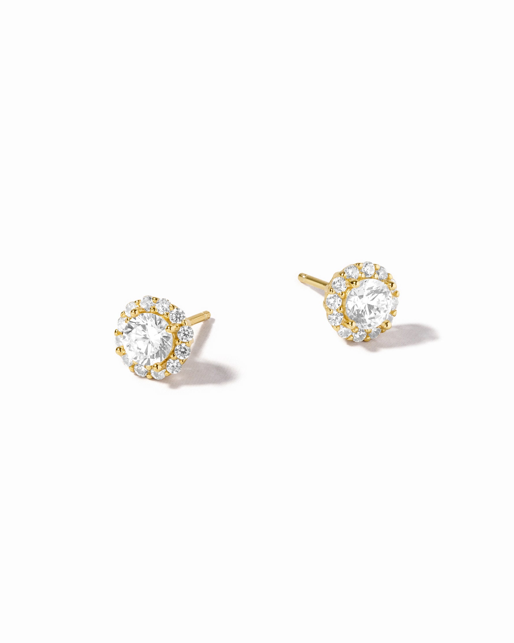 Gold diamond bridal earrings on a white background