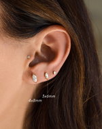 Model wearing bridal earrings, in the first hole a 4x8mm marquise stud earring, in the second hole, a 3x6mm small earring, and in the third a pear cut small stud earring