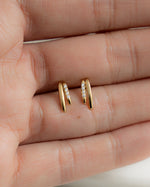 Models palm of hand holding cubic zirconia earrings