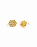 Gold unique earrings on a white background