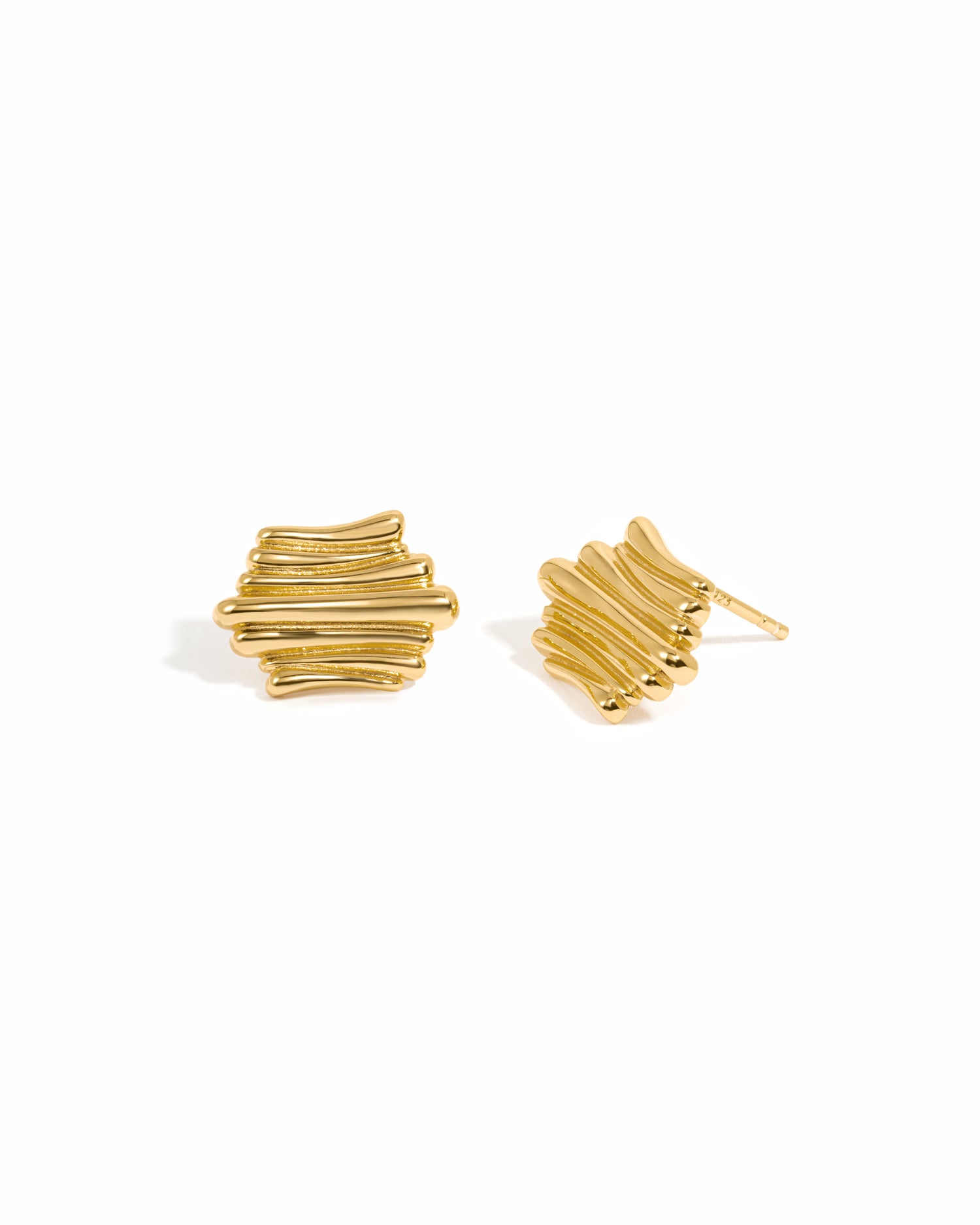 Gold unique earrings on a white background