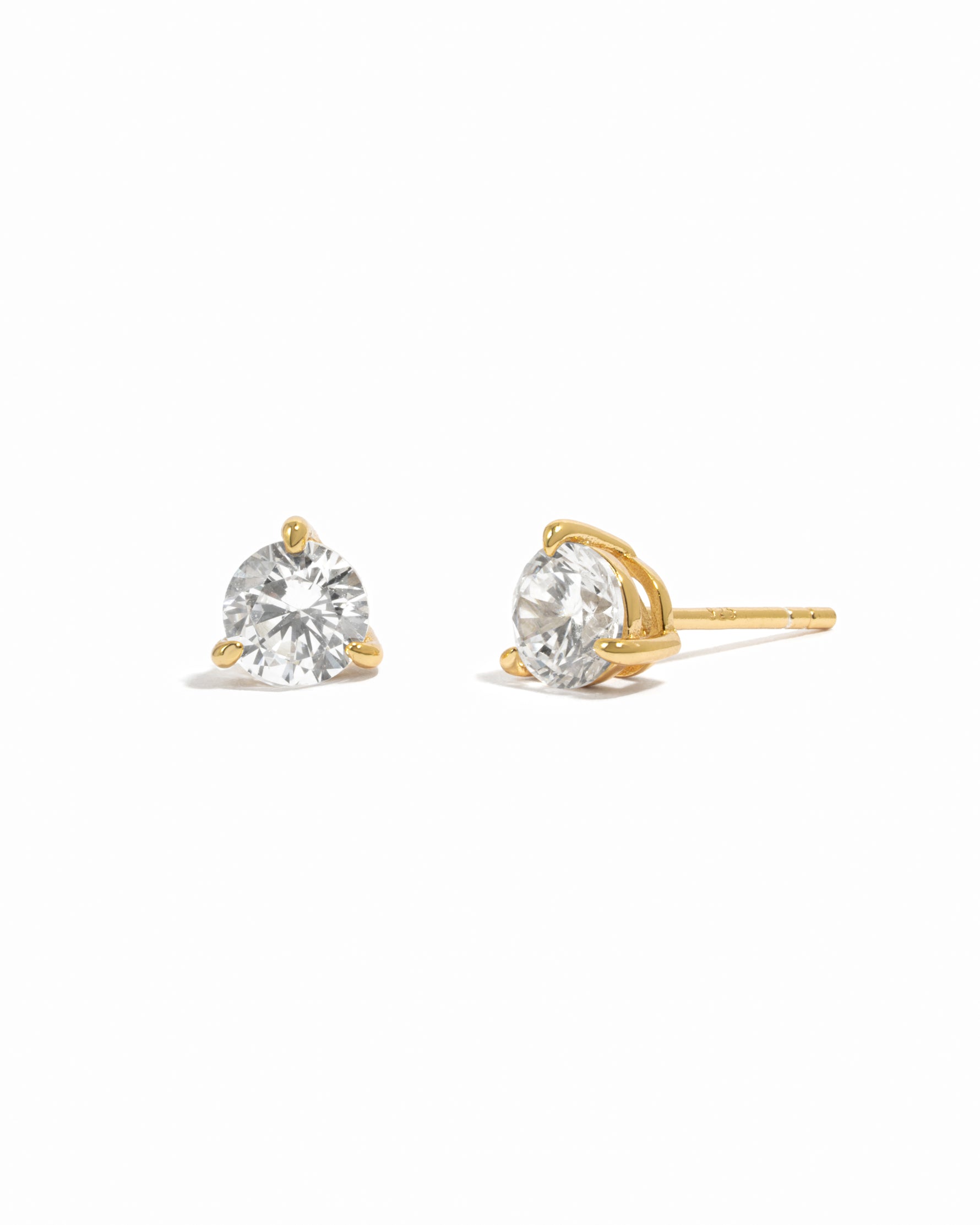Gold small diamond stud earrings on white background