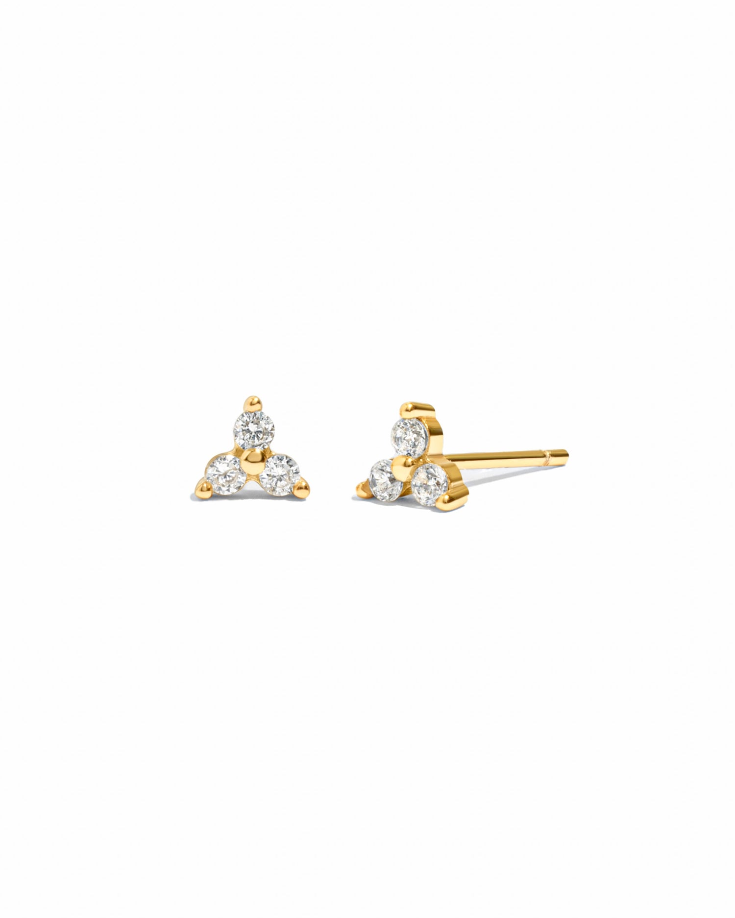 Tiny gold diamond stud earrings with three cubic zirconia stones