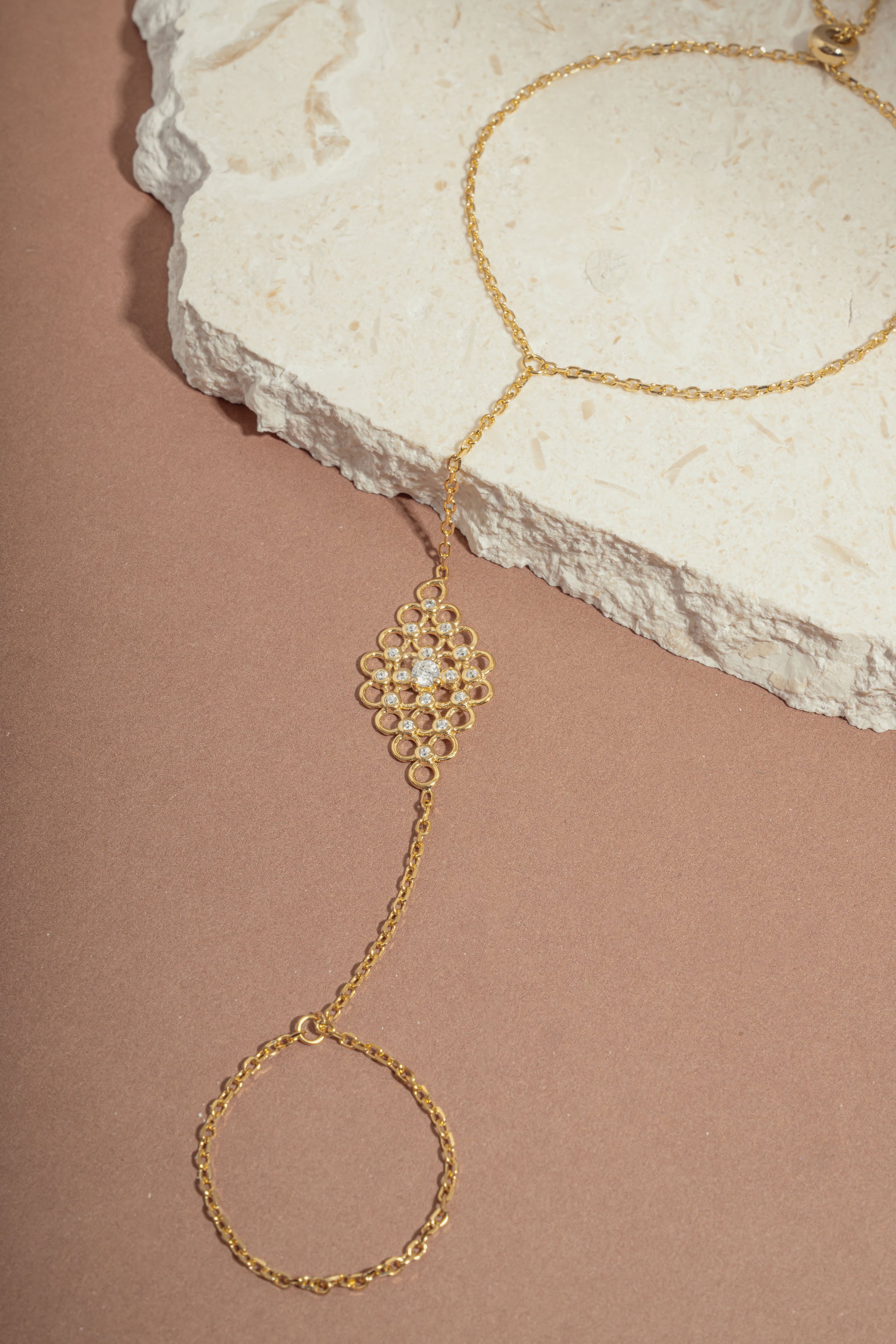 gold chain ring bracelet with cubic zirconia stones in the center