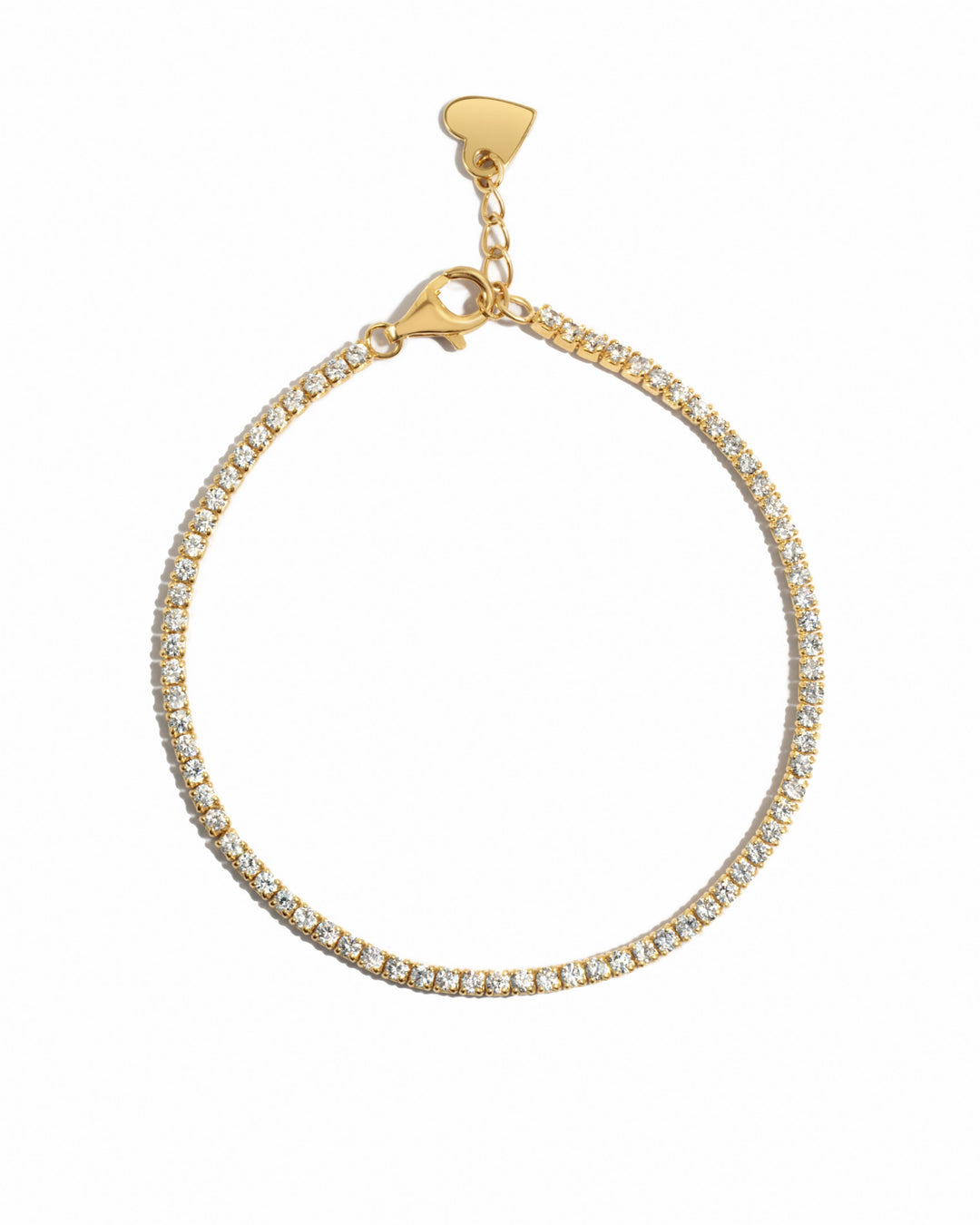 Delicate gold tennis bracelet on a white background