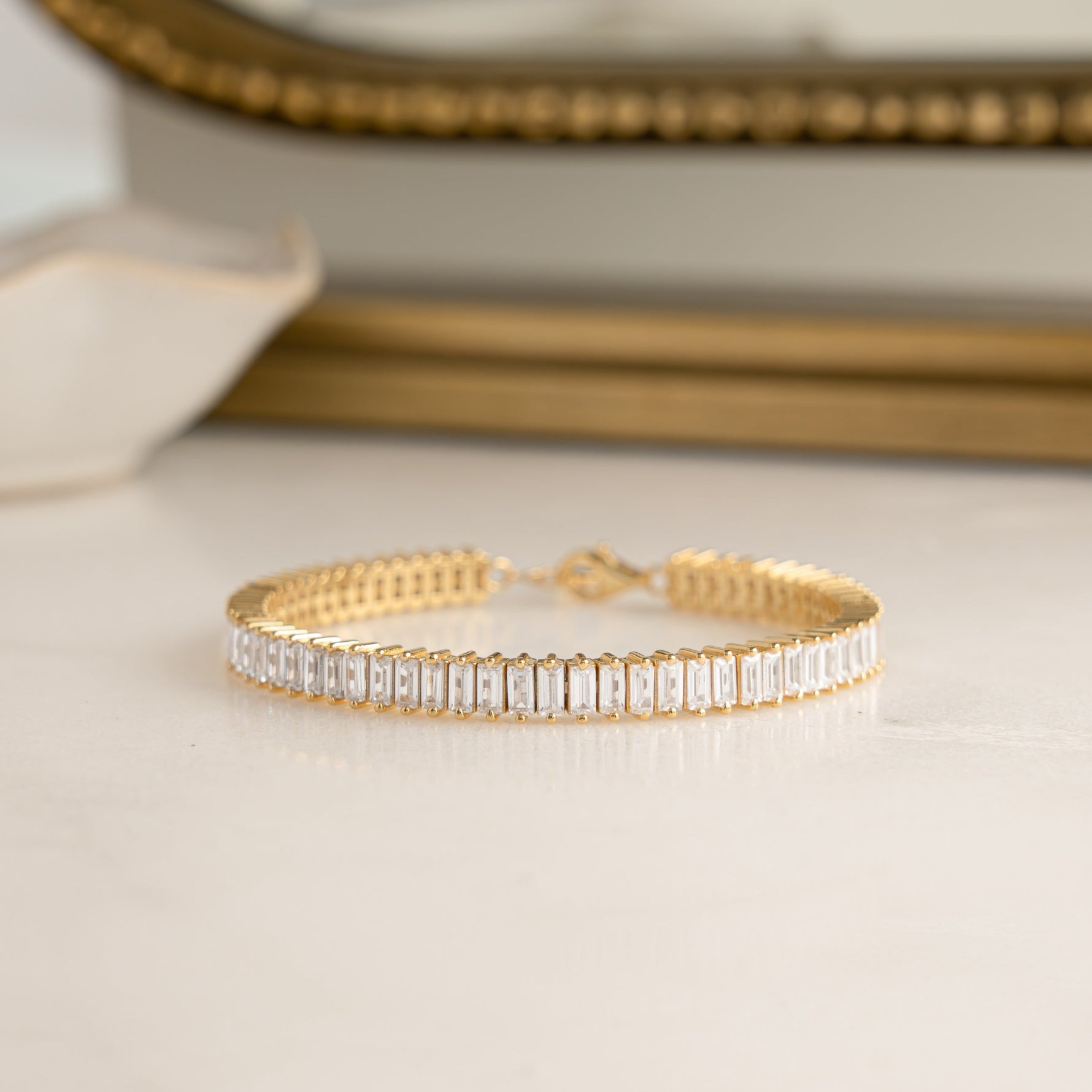 Closeup image of 14k gold plated baguette diamond tennis bracelet 