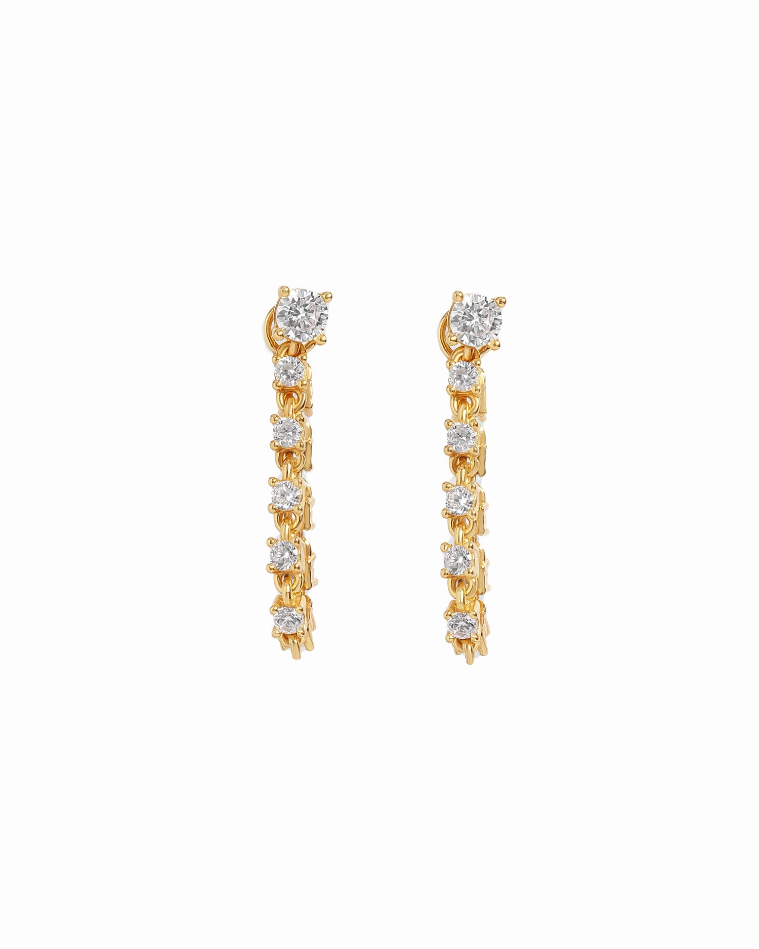 Gold tennis stud earrings with diamond-like stones on a white background