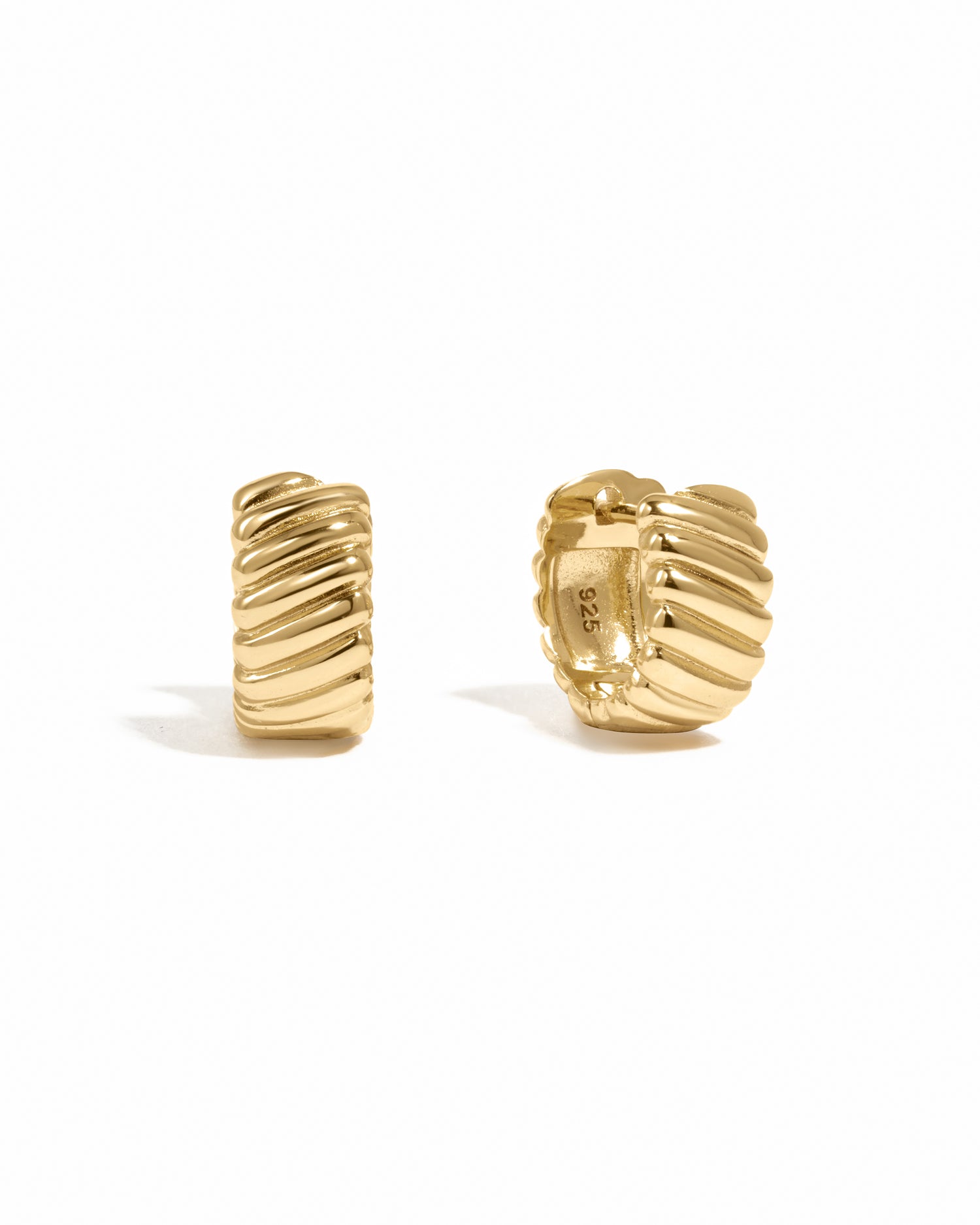 Gold small hoop earrings with a textured design on a white background