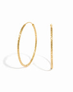 Gold lightweight earrings featuring a diamond hoop earring design on a white background