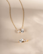 Gold necklace with matching dainty ring with a tear drop necklace and pearl ring design