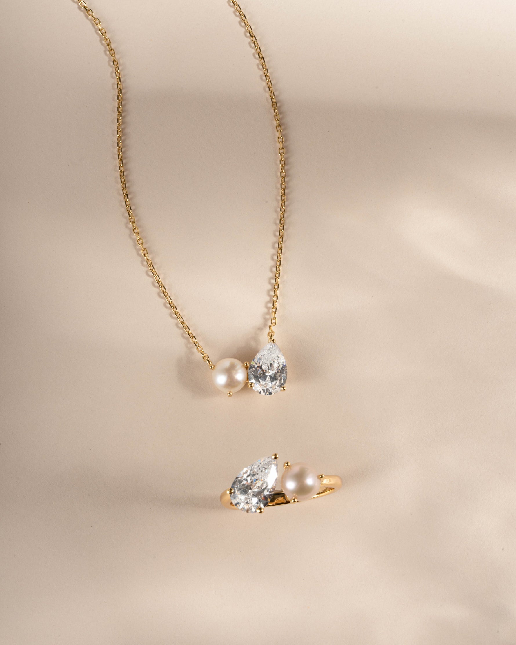 Gold necklace with matching dainty ring with a tear drop necklace and pearl ring design