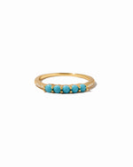 Gold ring with turquoise stones on a white background