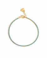 Gold turquoise tennis bracelet on a white background