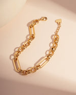 Gold chain vintage bracelet on a neutral background