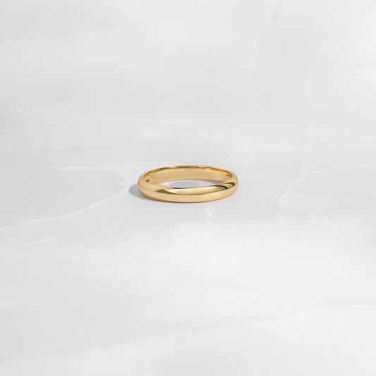 closeup of a sleek gold band with smooth, polished texture