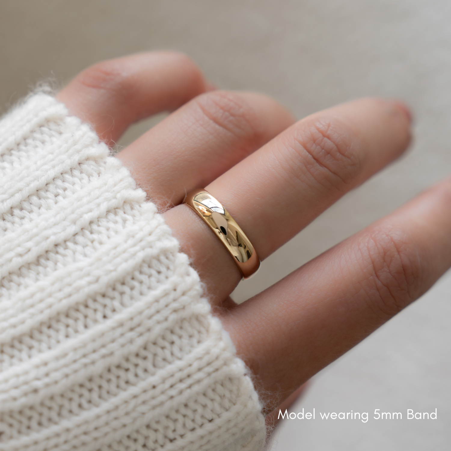 model wearing a gold band that measures 5mm wide