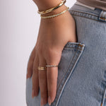 model wearing minimalist jewelry featuring diamond stacking ring