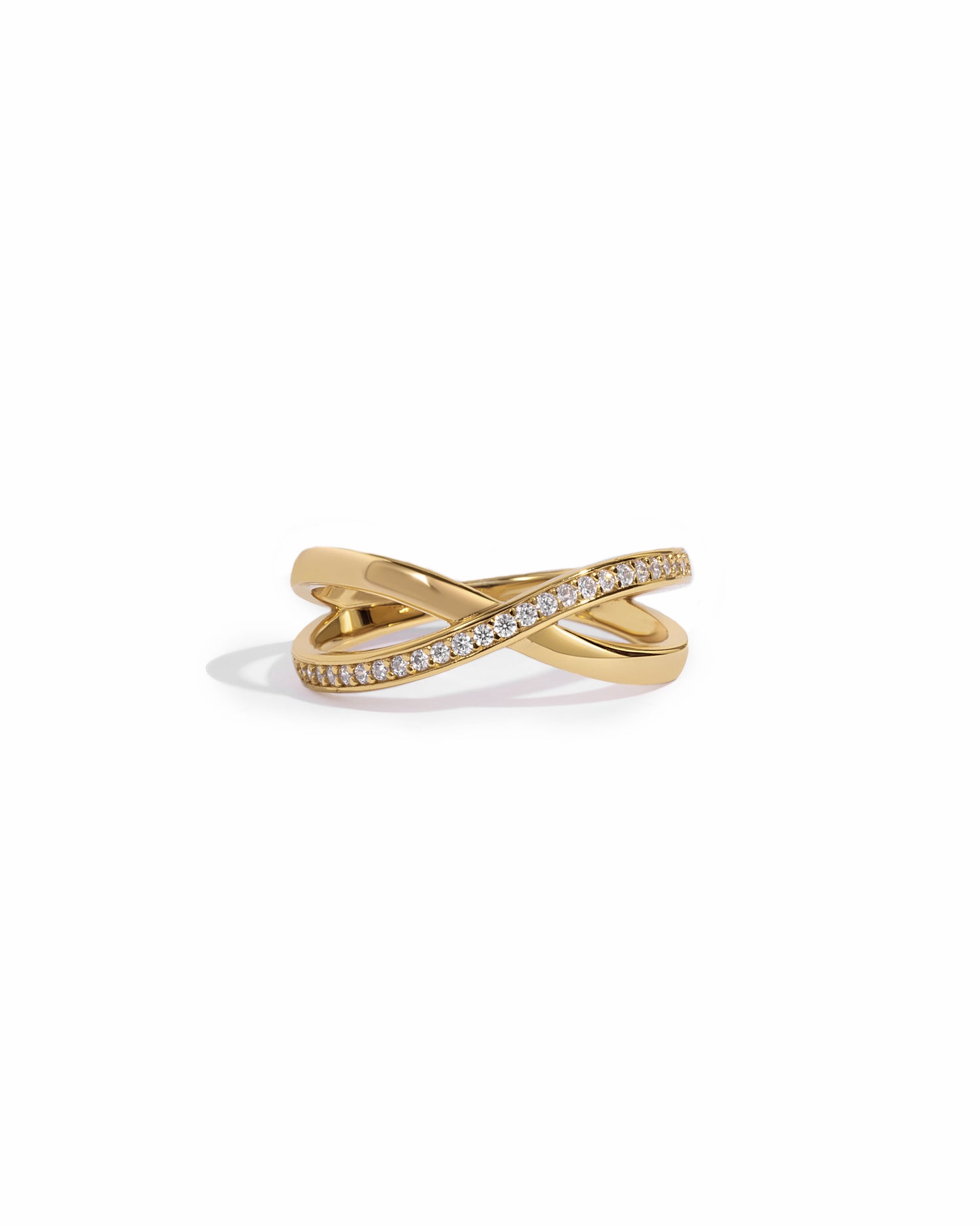 close up of gold wedding band with an X design