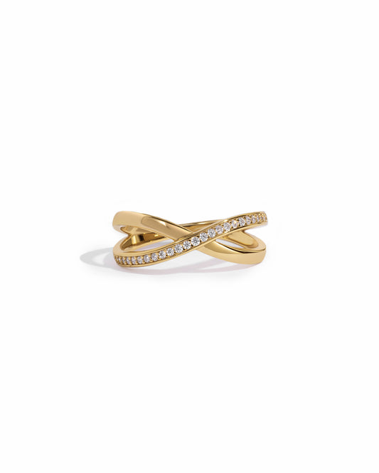 close up of gold wedding band with an X design