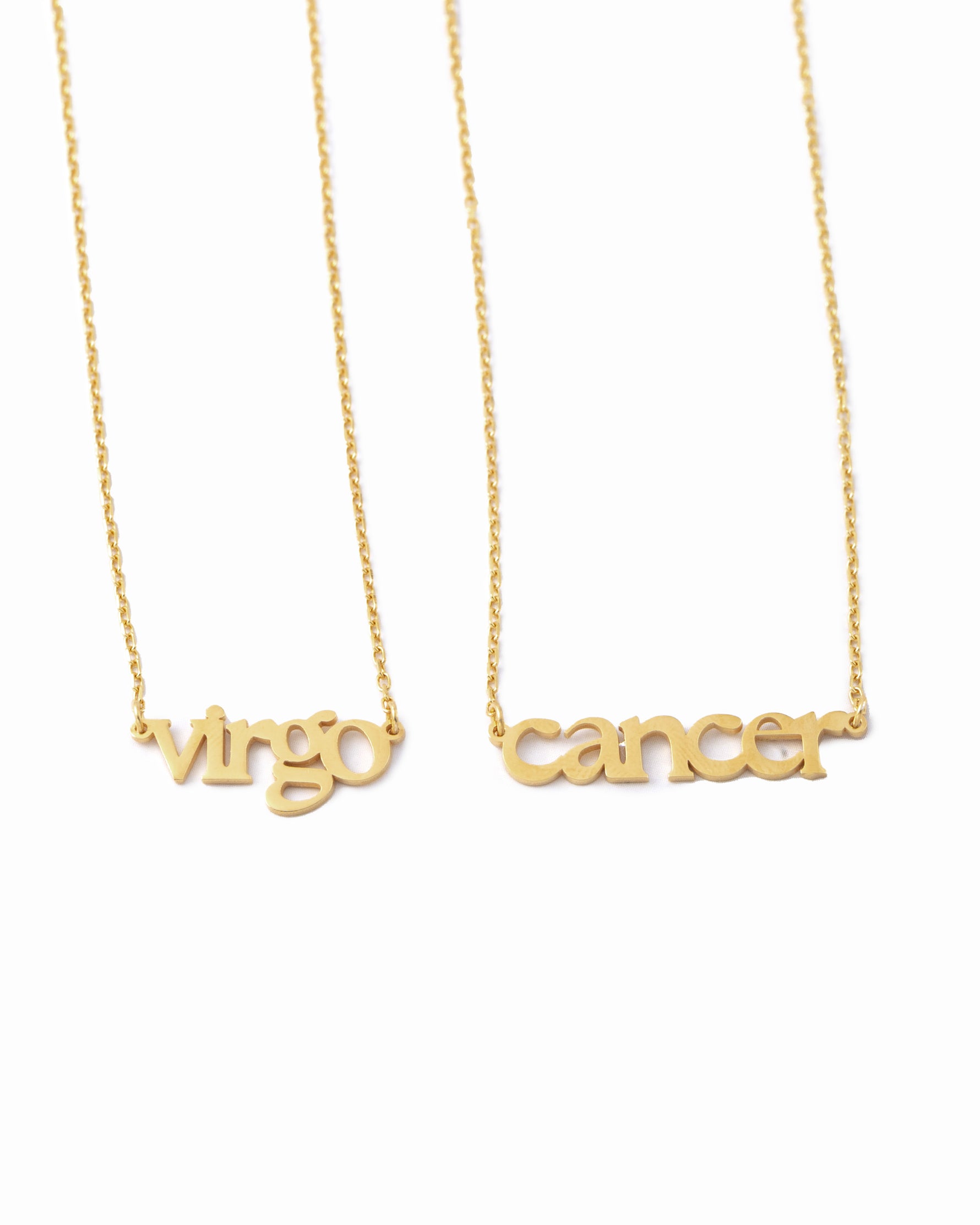 Gold necklaces with 'Virgo' and 'Cancer' writing on a white background