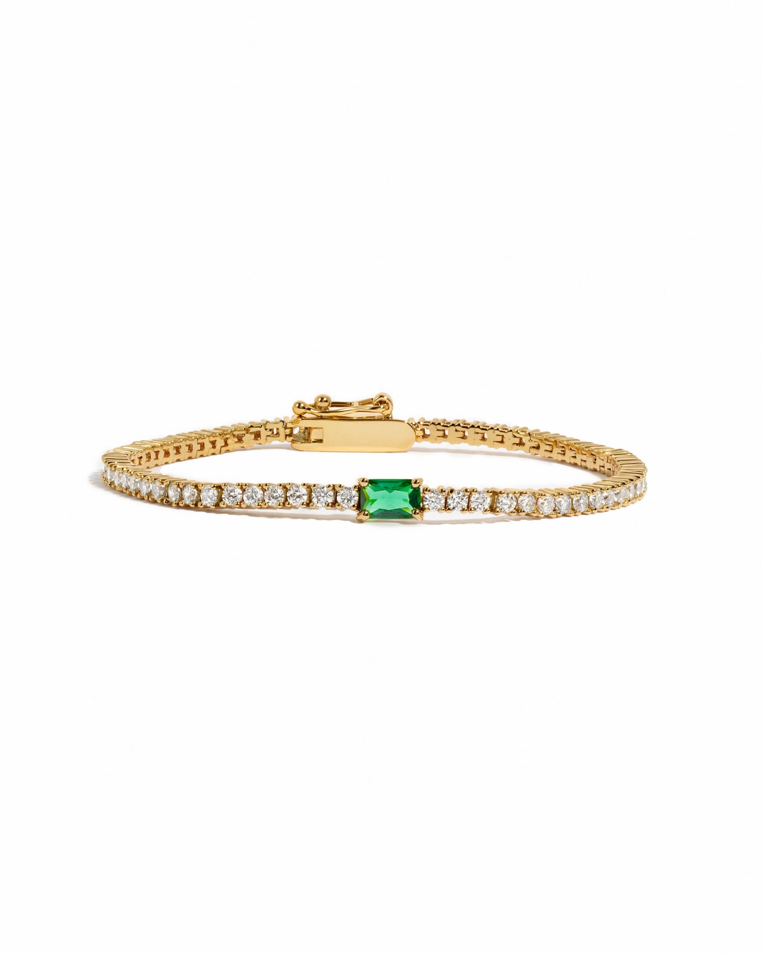 classic cubic zirconia gold plated tennis bracelet with an emerald baguette stone 