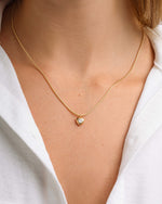 Model wearing dainty heart pendant necklace 