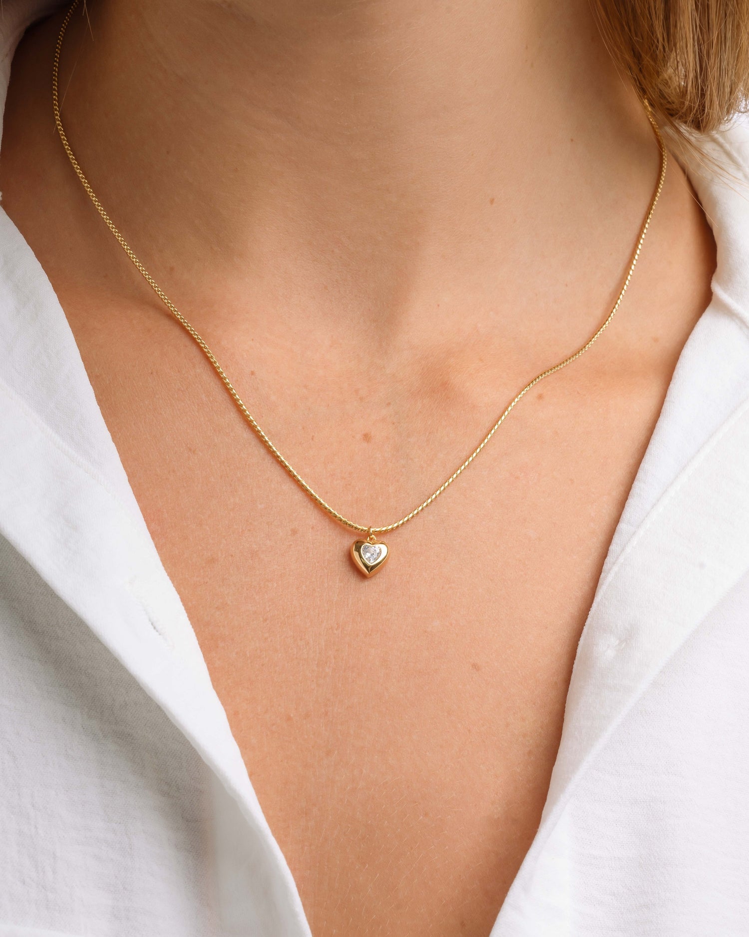 Model wearing dainty heart pendant necklace 