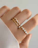 Gold bridesmaid jewelry featuring gold stackable rings, one diamond stacking ring paired with a simple ring band and a graduated promise ring