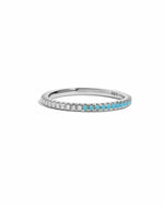 silver ring with half white cubic zirconia half turquoise stones on a white background