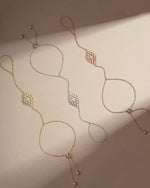 three adjustable hand chain bracelets, one gold hand chain, a rose gold ring bracelet, and a silver slave bracelet