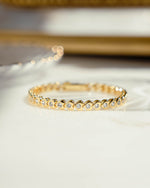 closeup image of gold heart shaped tennis bracelet