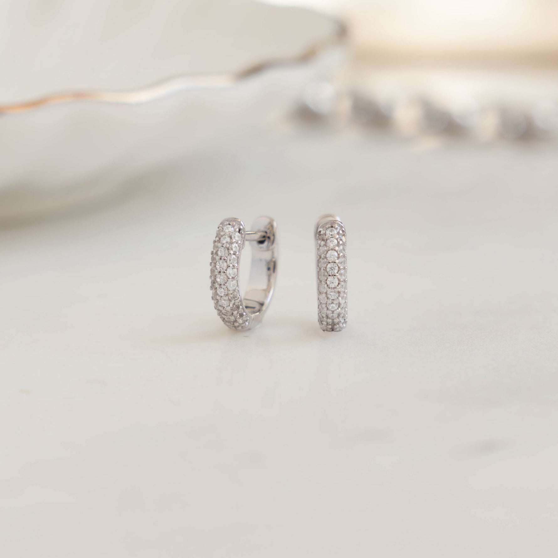 image of small silver huggie hoop earrings