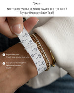Bracelet sizer tool being used on a wrist.