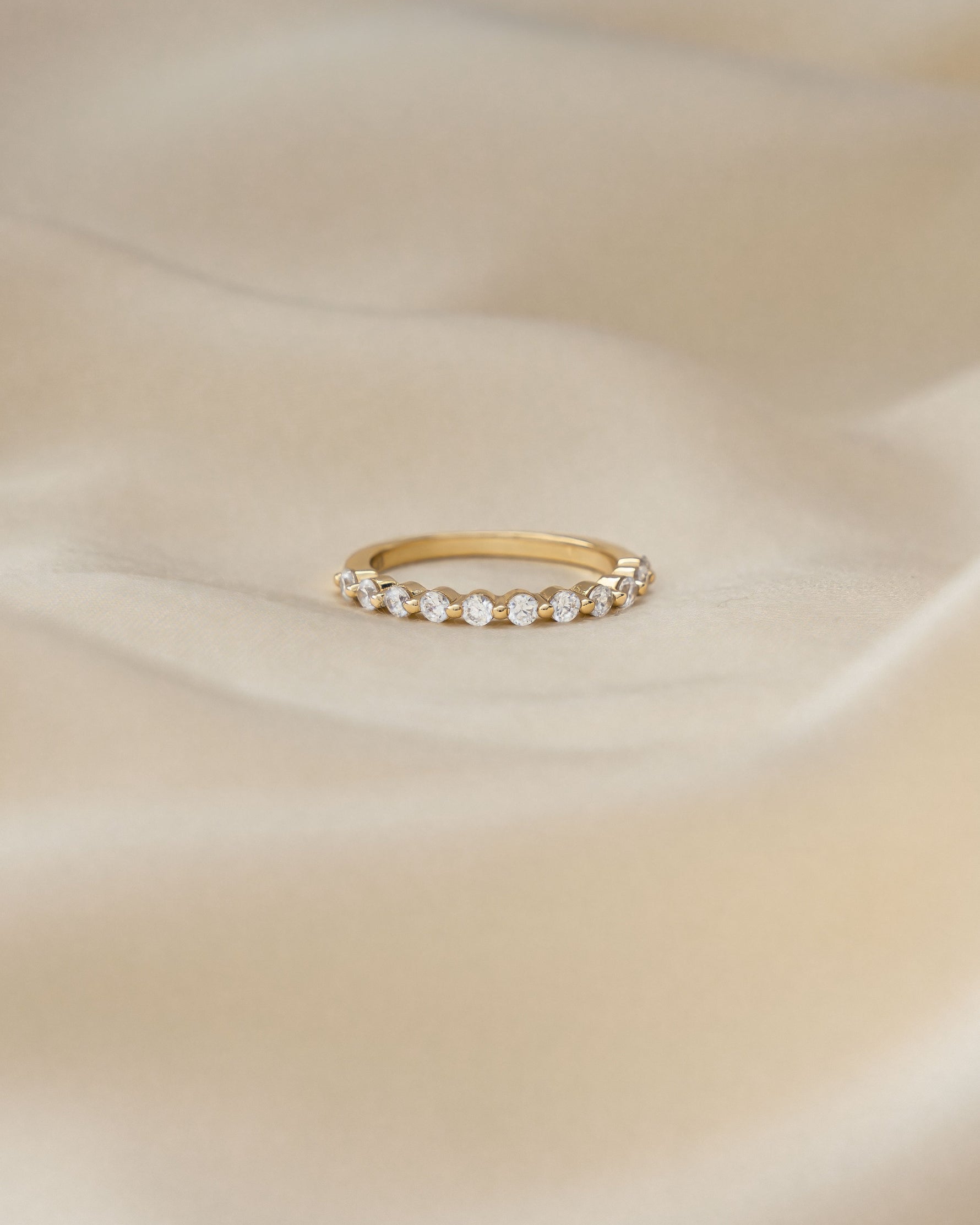 Gold minimalist ring on a silk background 