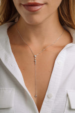 Model wearing sterling silver chain necklace with a lariat necklace design