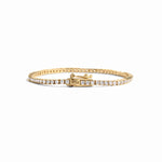 closeup image of gold tennis bracelet