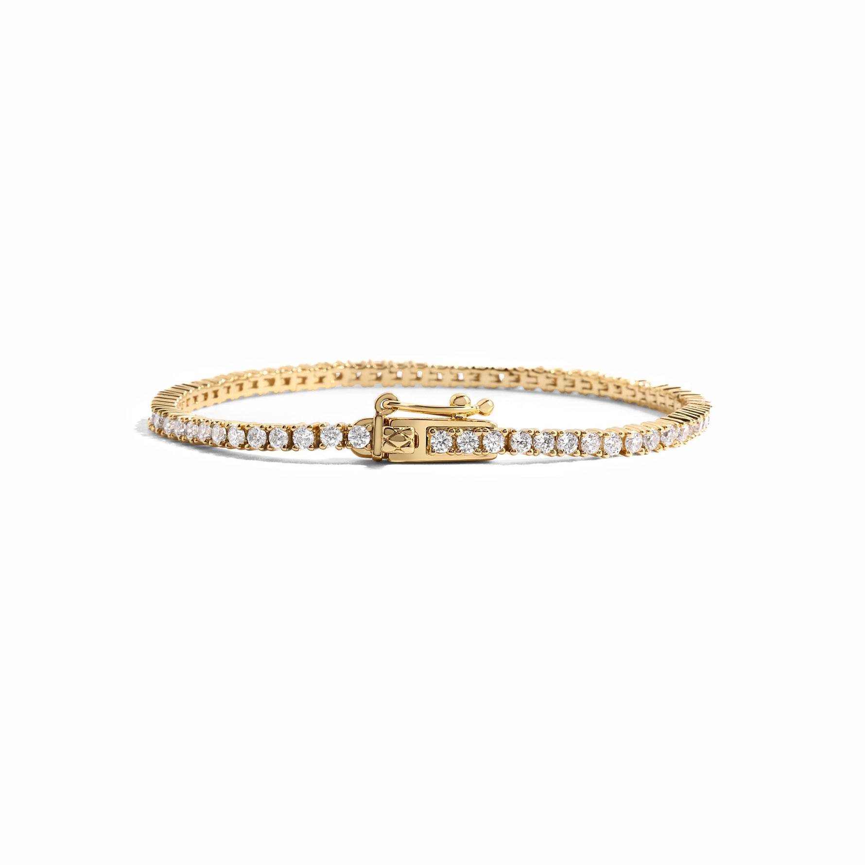 closeup image of gold tennis bracelet