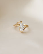 Closeup image of gold marquise engagement ring 