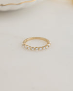 Gold plated stackable ring on a plain background 
