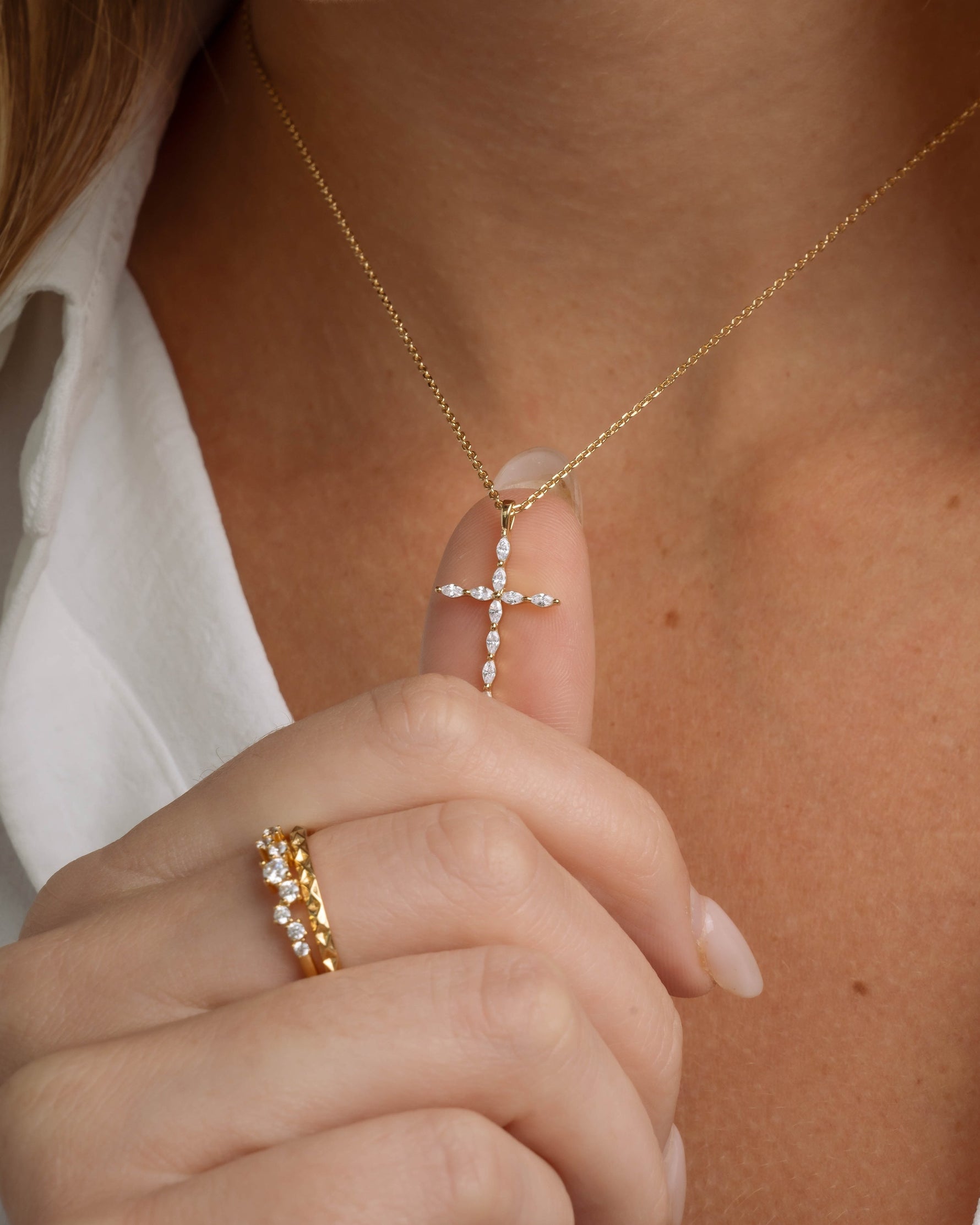 Model holding diamond cubic zirconia cross pendant 