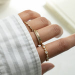 Model wearing 14k gold stacking rings 