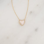 A detailed close-up of the gold diamond necklace, laid flat, highlighting the mother of pearl’s intricate details.