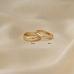 gold wedding bands in varying thicknesses, laid flat