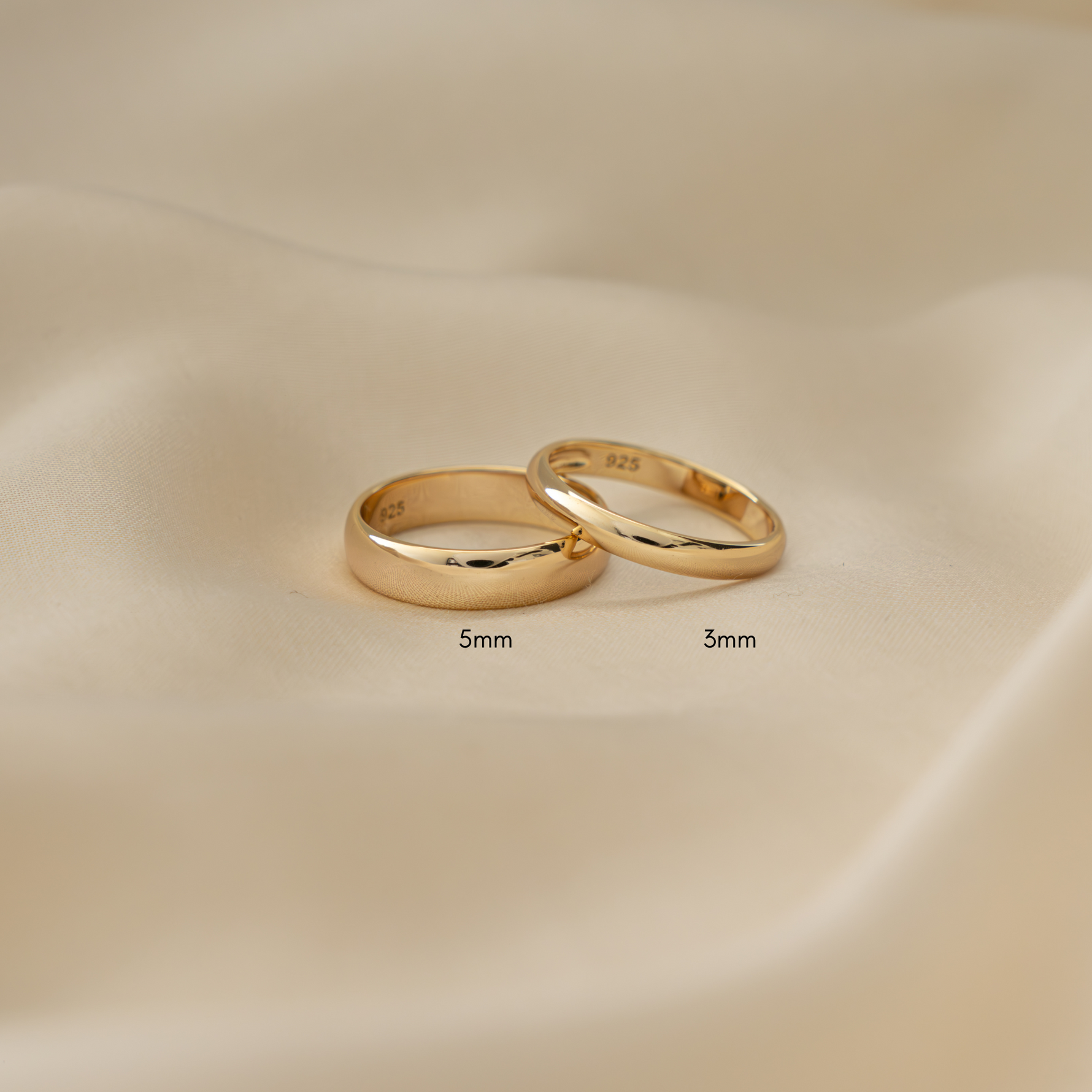 gold wedding bands in varying thicknesses, laid flat