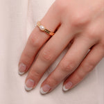 Model wearing dainty pearl ring