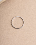 Sterling silver dainty ring on beige background
