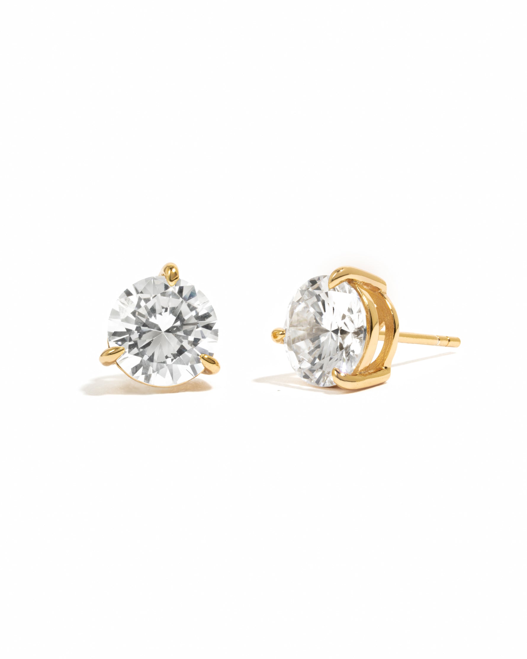 Cubic zirconia gold plated earrings on a white background