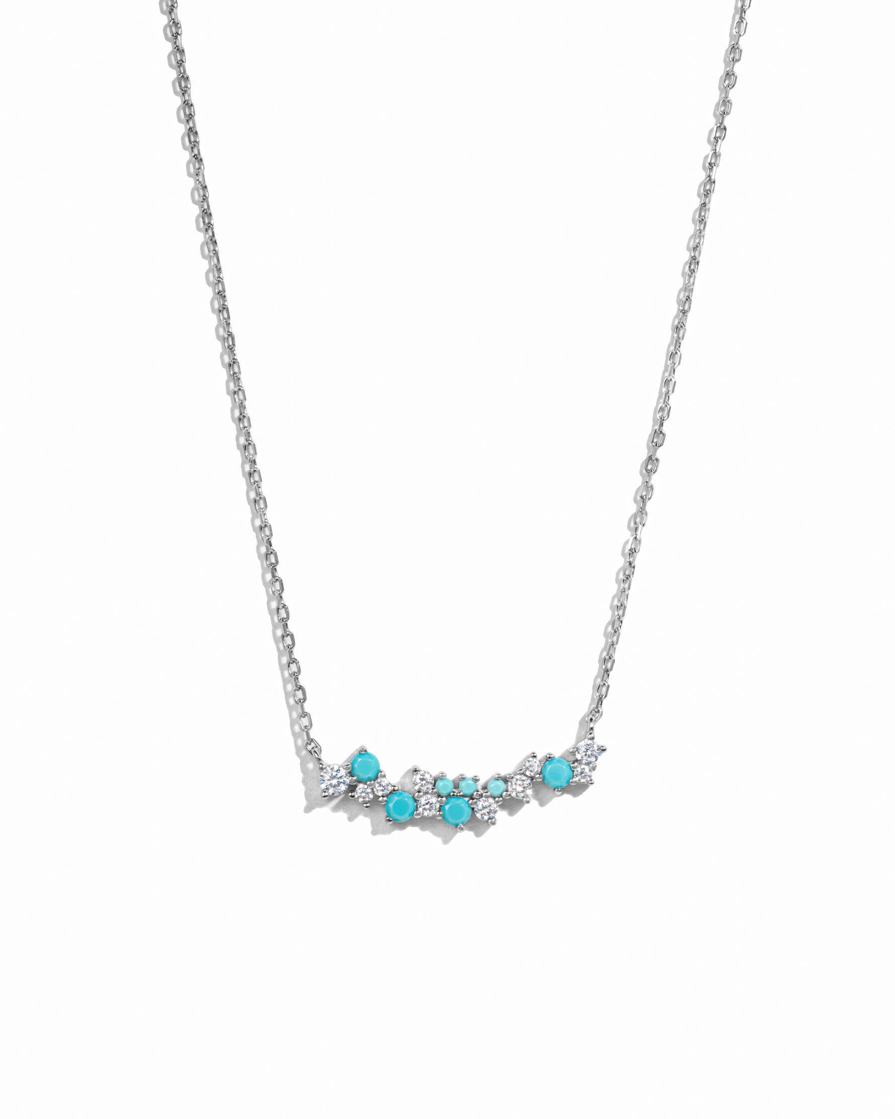 silver chain with turquoise pendant and cz and turquoise stones on a white background
