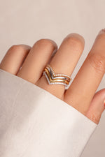 Model wearing stacked gold and silver mixed metals chevron ring set. 